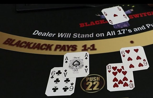 A blackjack switch felt printed with blackjack pays one to one and push on a total of twenty two