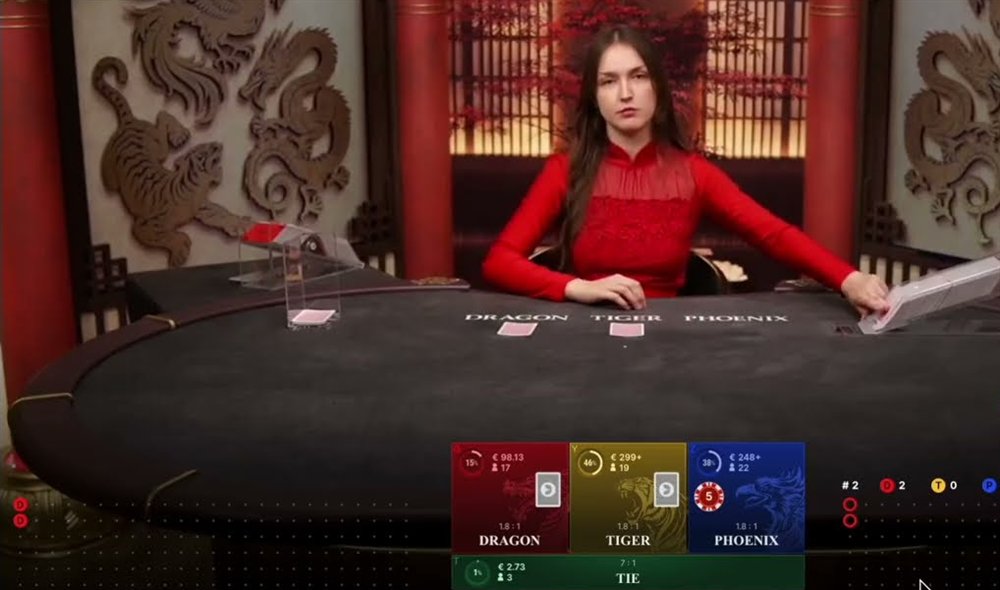 A dragon tiger phoenix live table mid-deal, with face-down cards on Dragon and Tiger and bet spots paying 1.8:1 on each hand and 7:1 on the Tie