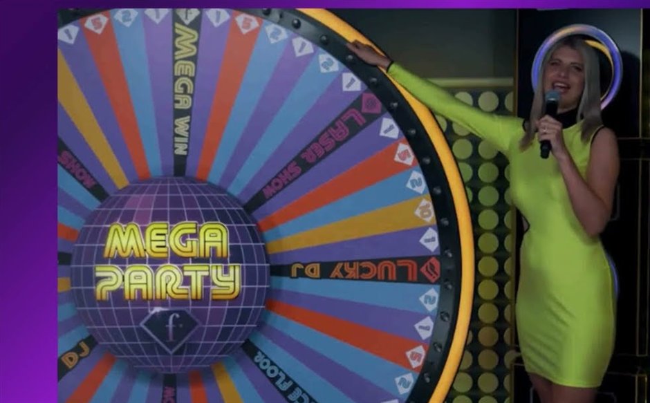 Fashion TV Mega Party presenter beside the wheel's Laser Show, Lucky DJ and Mega Win segments
