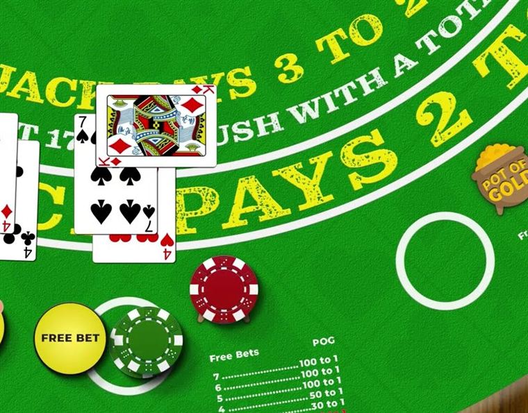 A free bet blackjack felt printed with blackjack pays three to two and push with a total of twenty two beside a yellow free bet marker