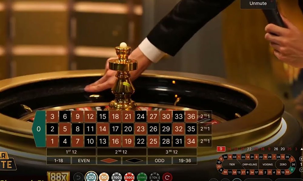 A gold bar roulette live table with the gold wheel, the betting layout and the 88x Gold Bar chip in the tray