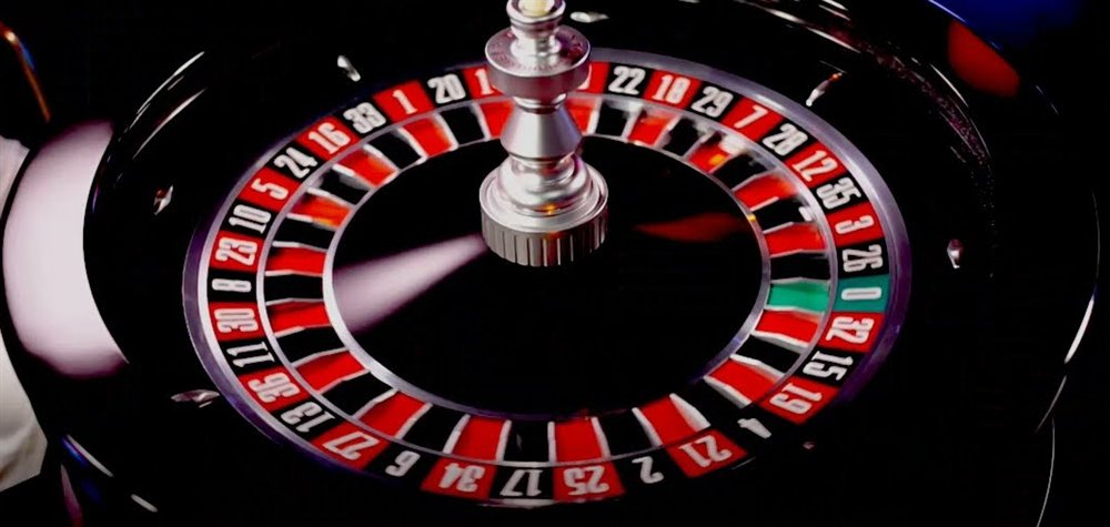 Close-up camera view of the immersive roulette live wheel with the ball spinning past the numbered pockets and the green zero