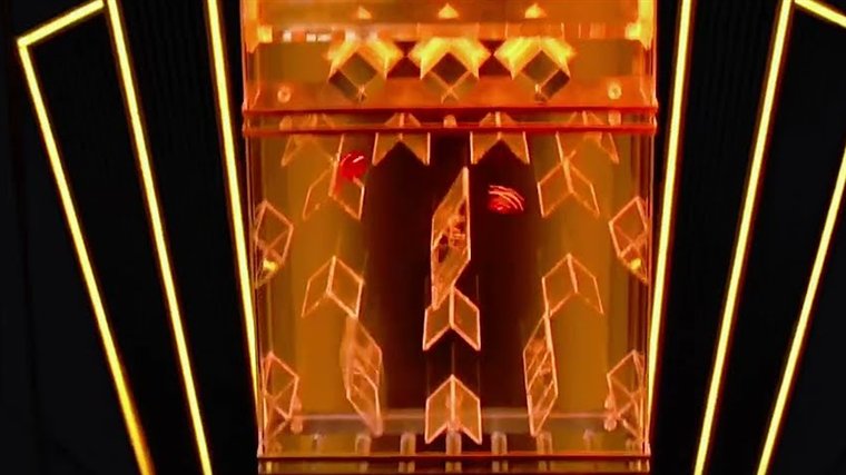 The lightning dice live Lightning Tower, a transparent maze of angled obstacles lit in orange inside an Art Deco frame