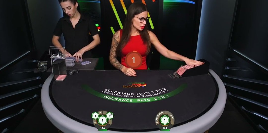 Majority Rules Speed Blackjack dealer at the table as a second dealer prepares the next shoe