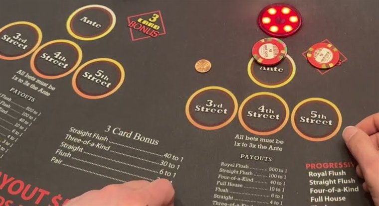 A mississippi stud layout with chips in the street circles and the three card bonus spot marked