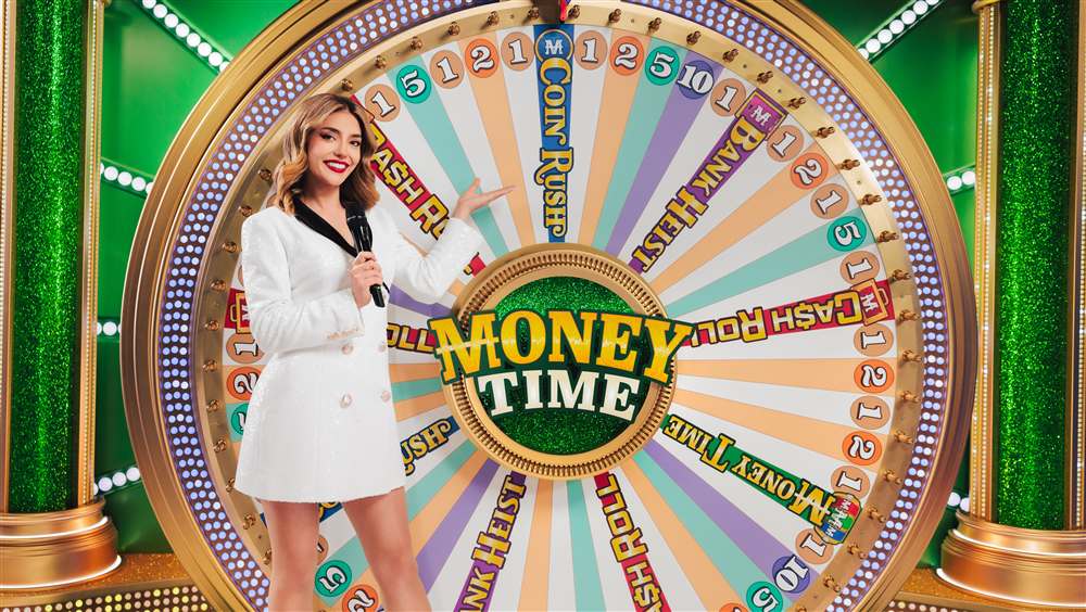 Money Time host in a white jacket beside the 54-segment wheel with Cash Roll, Coin Rush, Bank Heist and Money Time segments