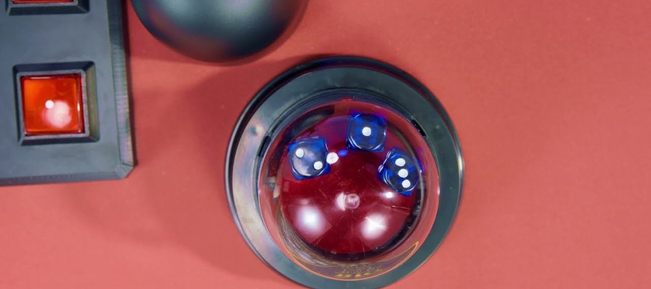 A top down view of a sic bo dome with three dice settled after a throw