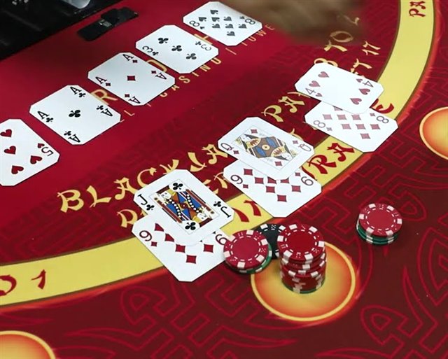Several Spanish 21 hands dealt across the felt with chips in the betting circles