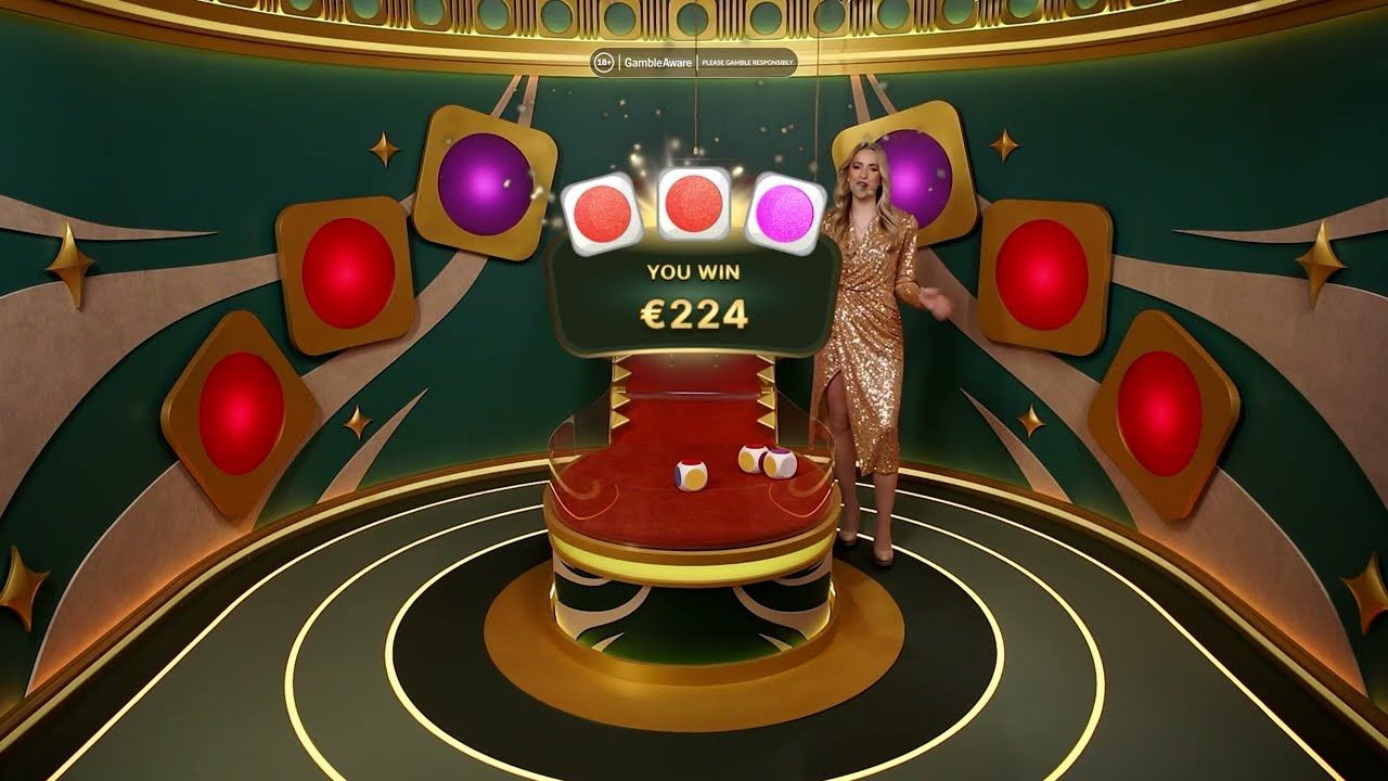 Super Color Game Live result with three colour dice on the platform and the host behind a You Win total