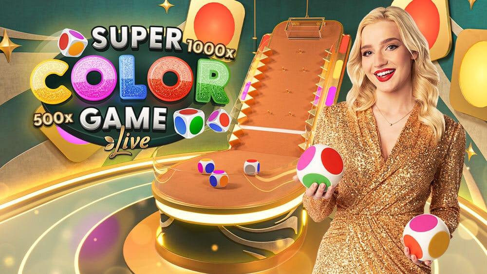 Super Color Game Live key art with the host in a gold dress holding colour dice beside the pin-lined chute and platform