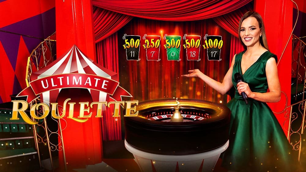 Ultimate Roulette key art with the circus big top logo, the presenter in green beside the wheel and 500x and 1000x multiplier cards