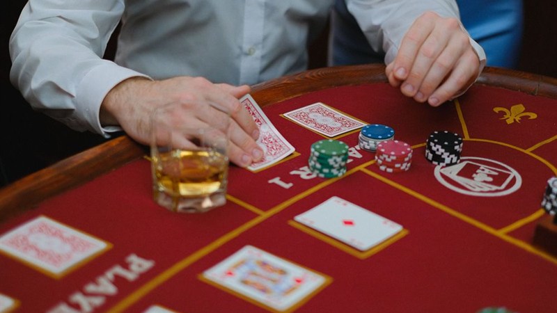 Baccarat table with cards and chips beside the player box
