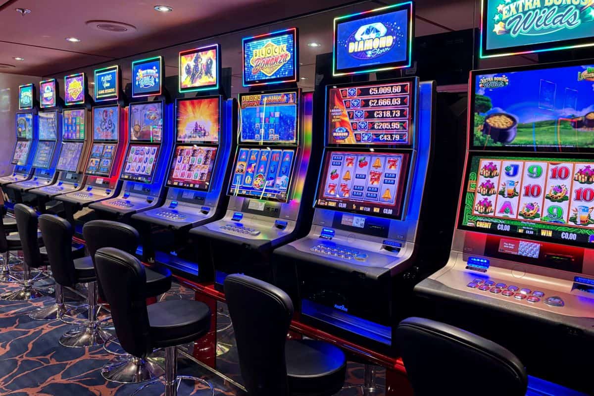 Row of glowing slot machines with black stools, the games behind 100 free spins no deposit Canada offers