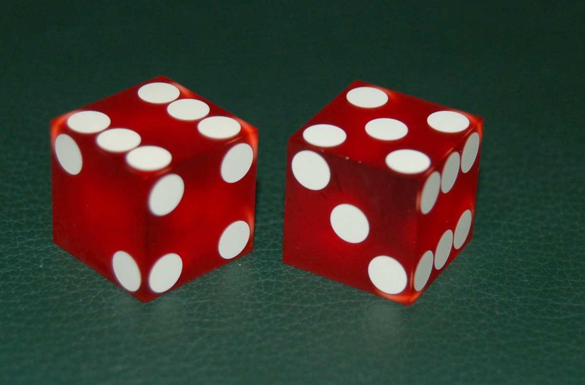 Craps dice on a casino table, home of the zero edge odds bet among casino games with the best odds Canada players can find