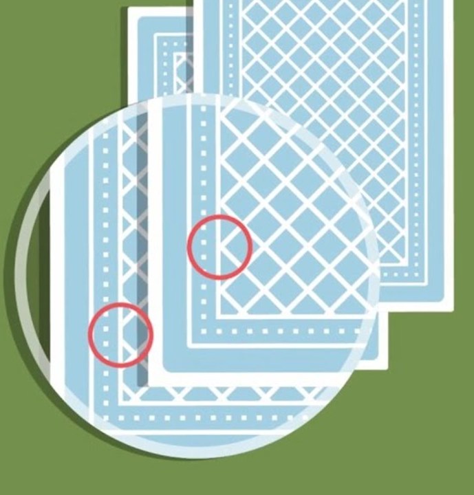Illustration of two card backs under a magnifier, with circles marking uneven edge patterns
