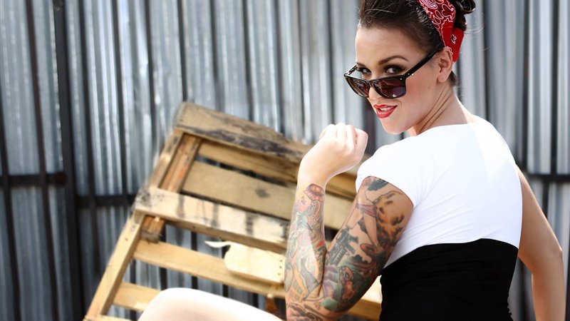 Tattooed model in sunglasses and a red bandana, from FuckFinder's FAQ page, for this FuckFinder review Canada