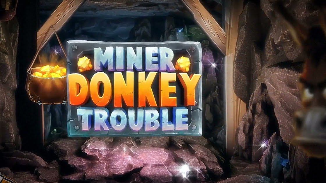 Miner Donkey Trouble title sign inside a gold mine with a pot of gold nuggets, the Miner Donkey Trouble slot Canada players spin