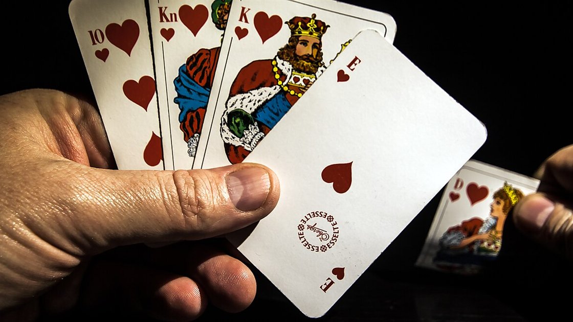 A player holding a royal flush in hearts