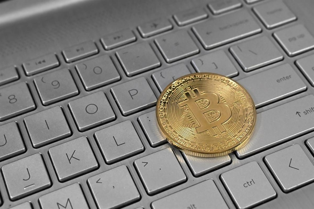 Bitcoin coin on a laptop keyboard, the main currency at Stake Casino Canada