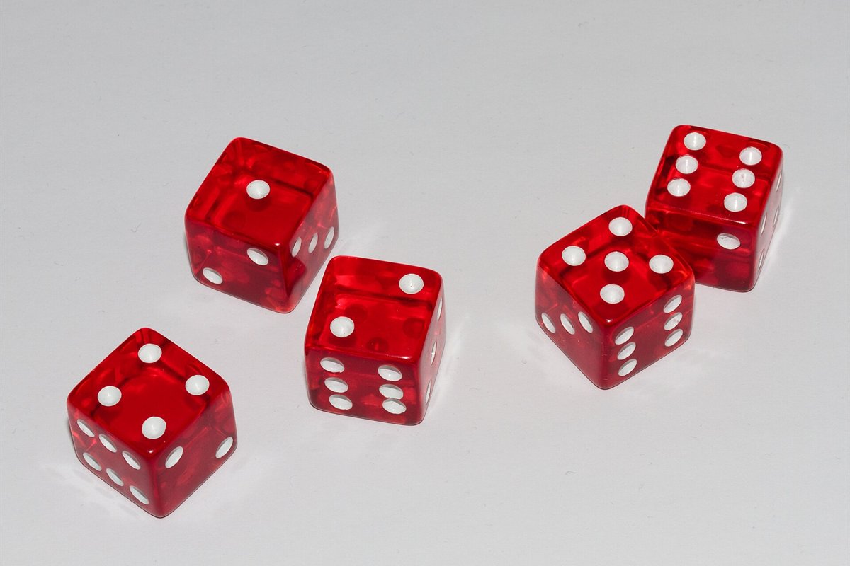 Five red casino dice showing different faces