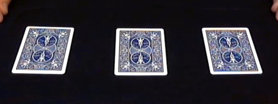 Three face-down cards laid out for a game of three card monte