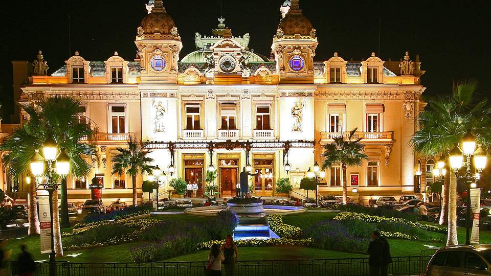 Casino de Monte-Carlo lit at night, a symbol of high-stakes play in why the wealthy gamble Canada discussions